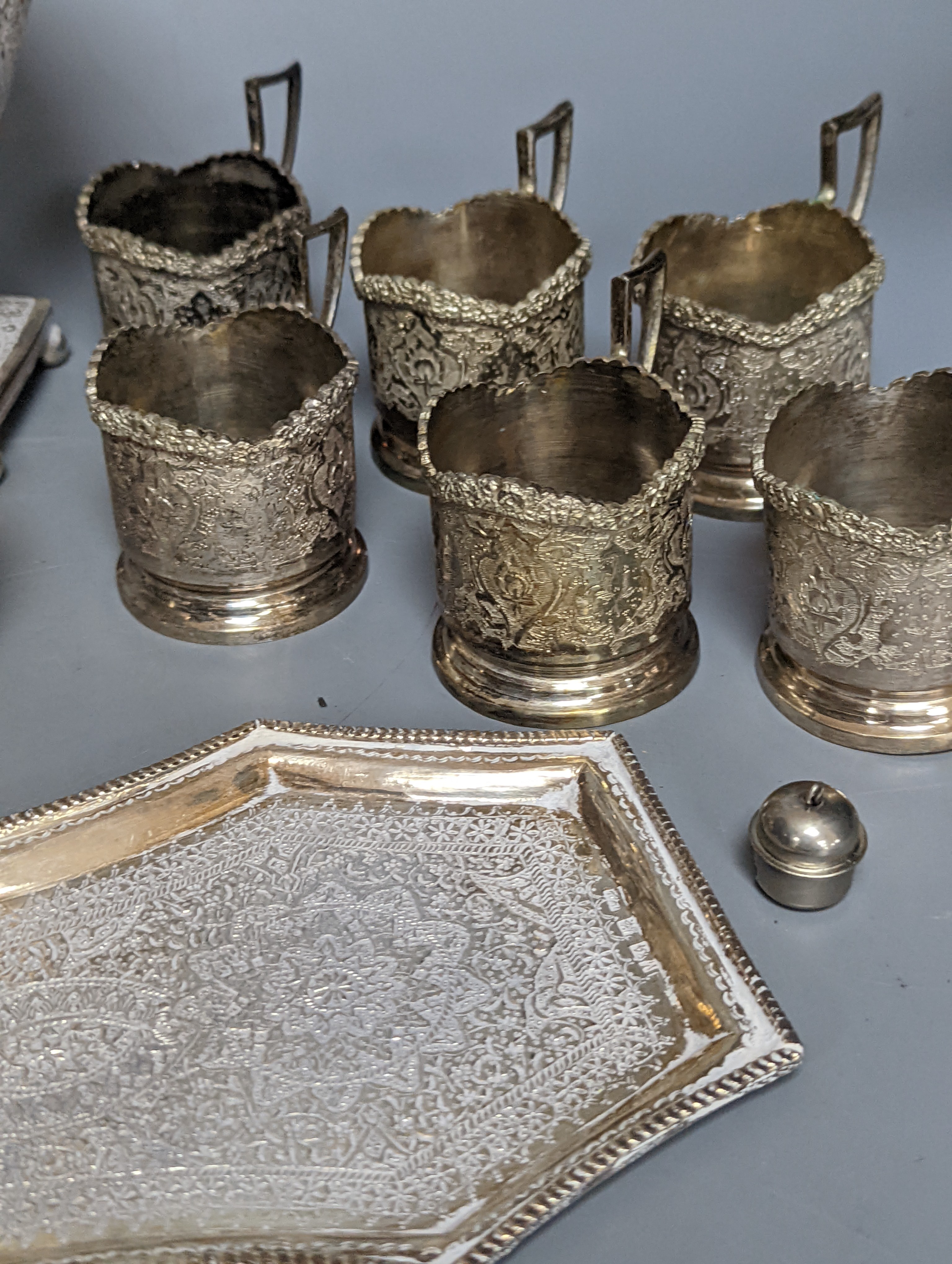 A set of six Persian embossed 84 standard white metal coffee cup holders and matching sugar bowl and cover by Vartan and four other Persian white metal items.